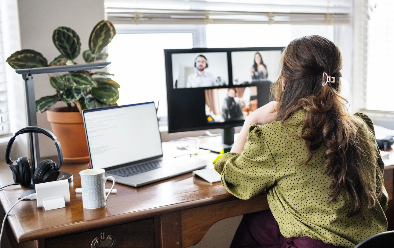 Woman working from home office having video call with business team during remote meeting on laptop computer